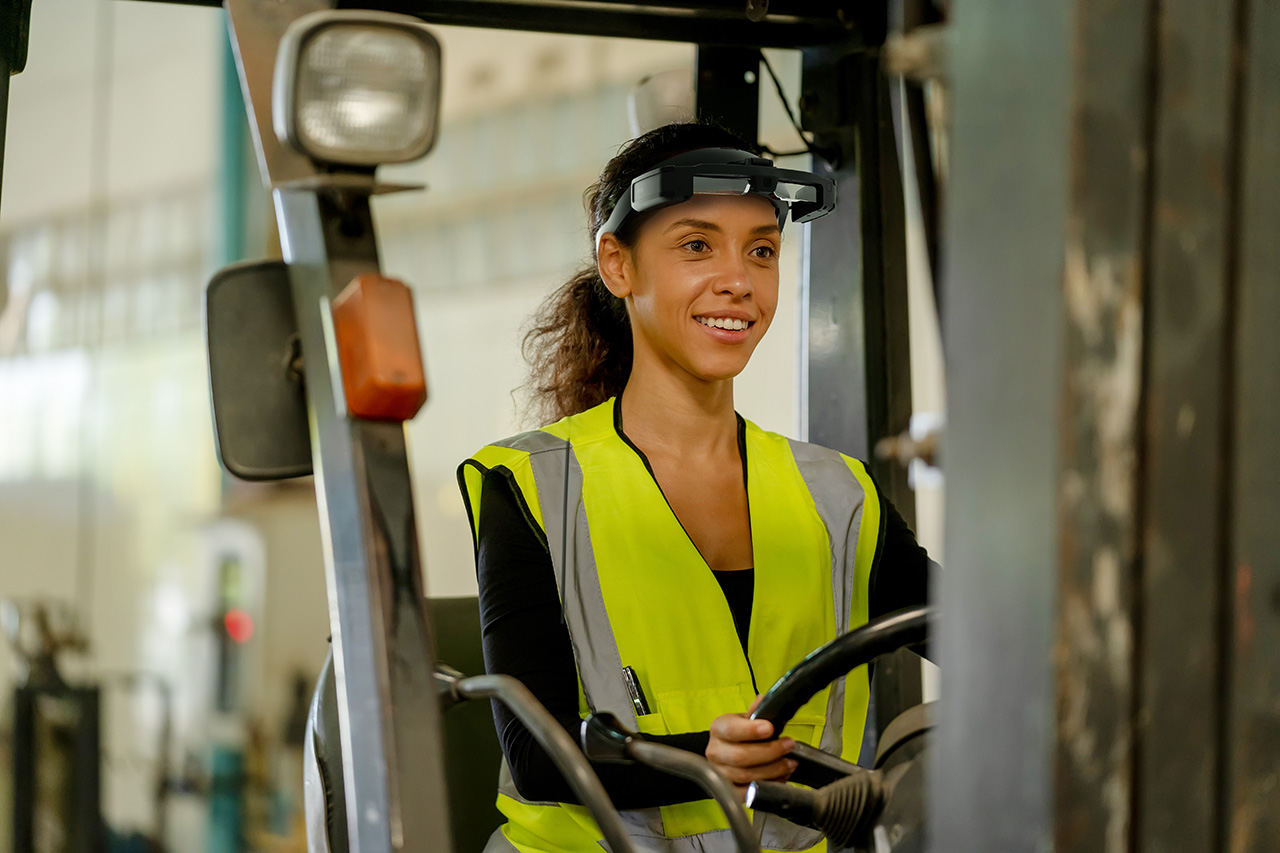 Industrial factory women are driving forklift at lathes factory.